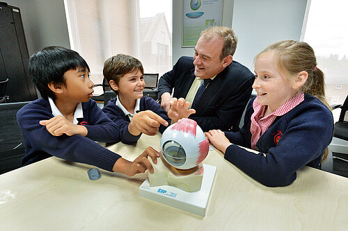 Ed Davey talking to children in a classroom